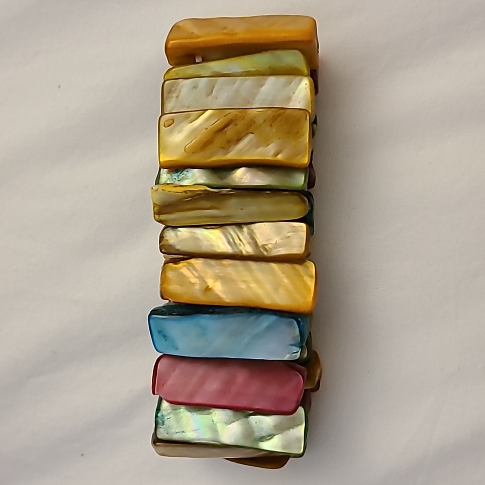 Multicolored stretch bracelet, shell-like material.  About 1 inch long.